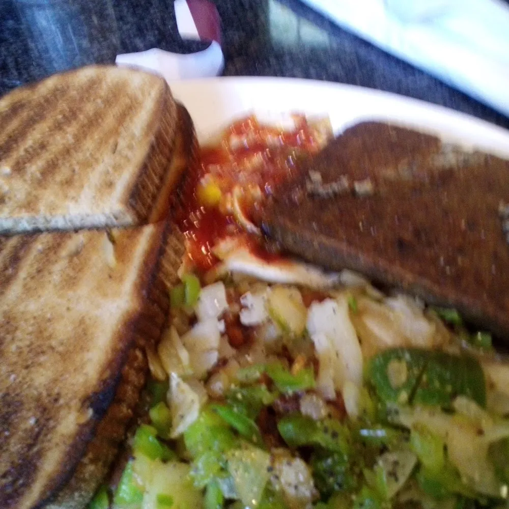 Coffee Two Eggs over Easy Hash Browns with Peppers Right Toast and Jelly